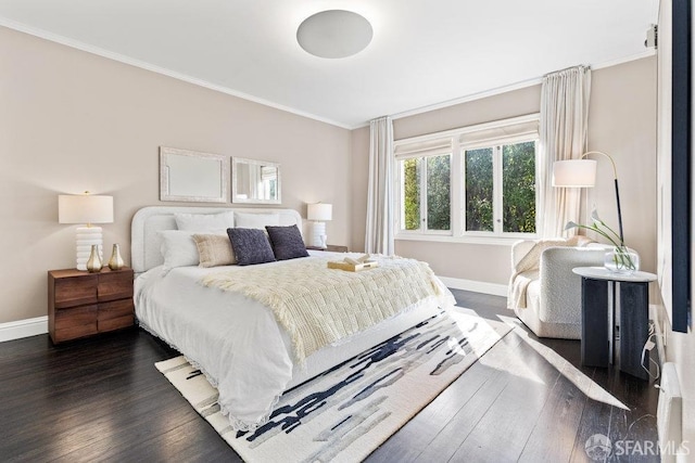 bedroom with baseboards, ornamental molding, and dark wood-style flooring