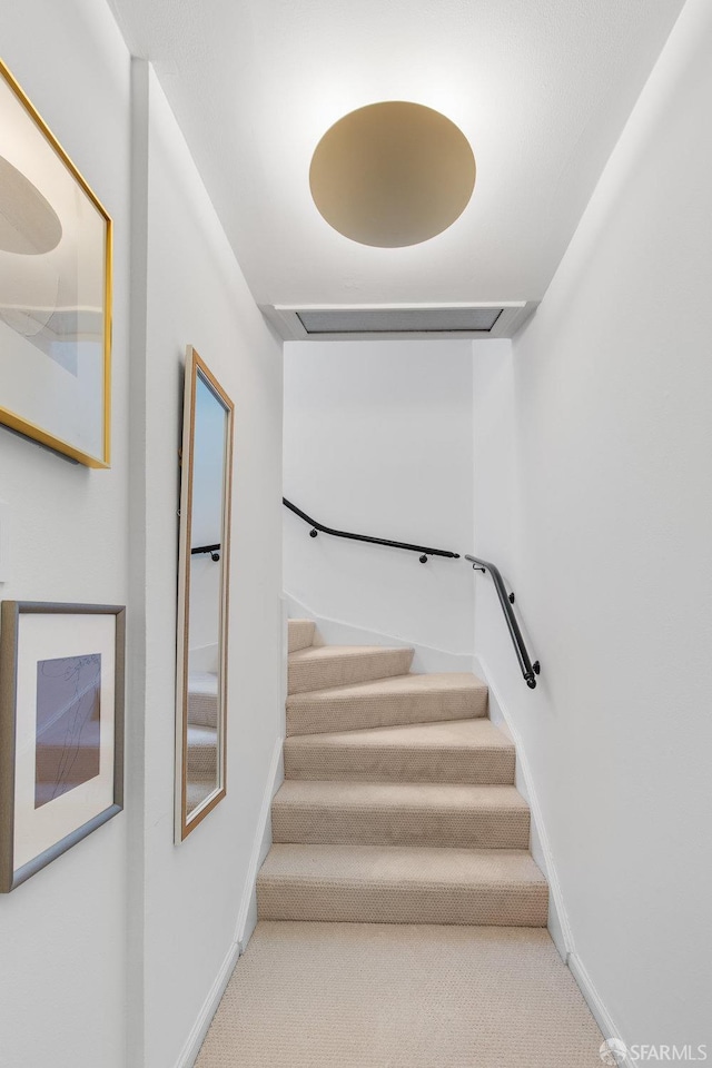 stairway with carpet flooring and baseboards