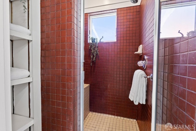 bathroom with tile walls and tiled shower