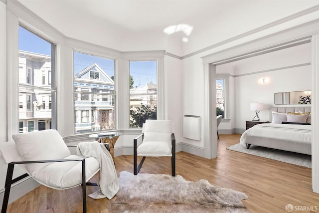 bedroom featuring light wood-style floors and baseboards