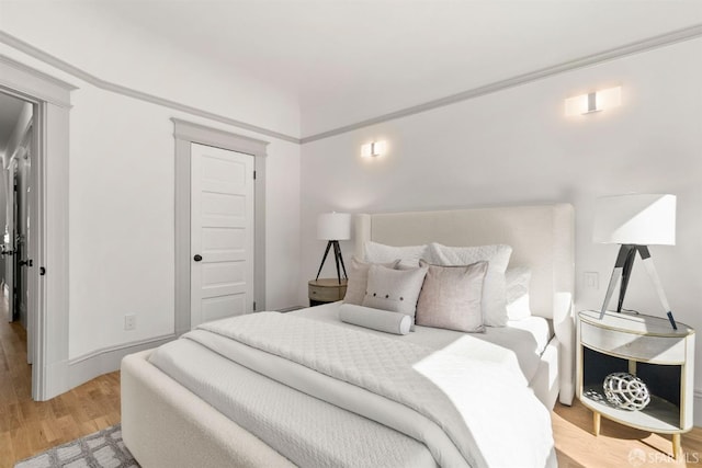 bedroom featuring light wood-type flooring and baseboards