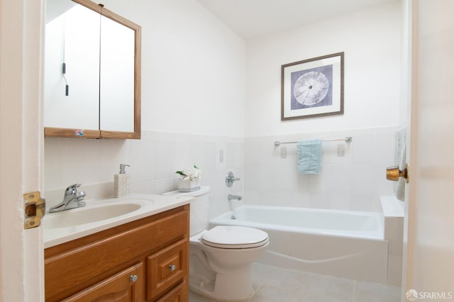 bathroom with tile patterned floors, toilet, tile walls, vanity, and a bathing tub