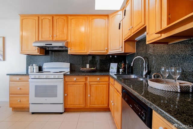 kitchen with sink, light tile patterned floors, white gas range, dishwasher, and dark stone counters