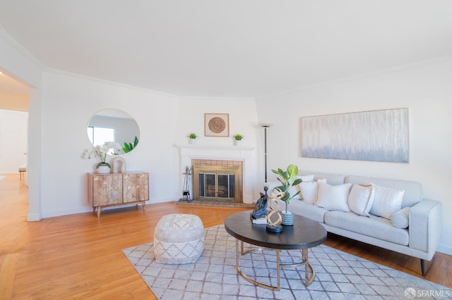 living room featuring crown molding, hardwood / wood-style floors, and a brick fireplace