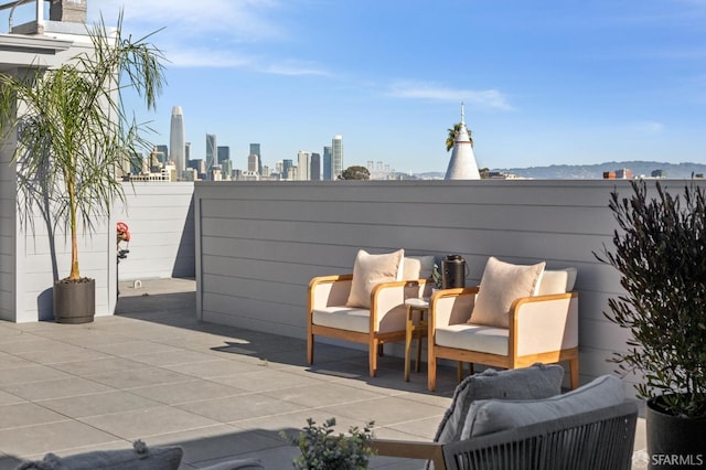 view of patio with an outdoor hangout area and a city view