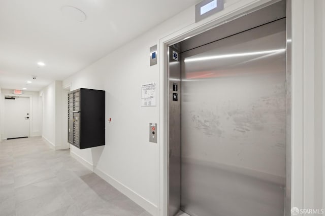 hallway featuring recessed lighting, elevator, and baseboards