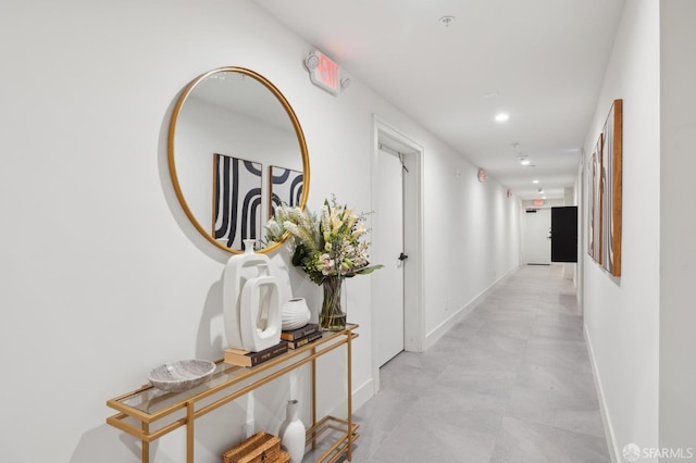 hall with recessed lighting and baseboards