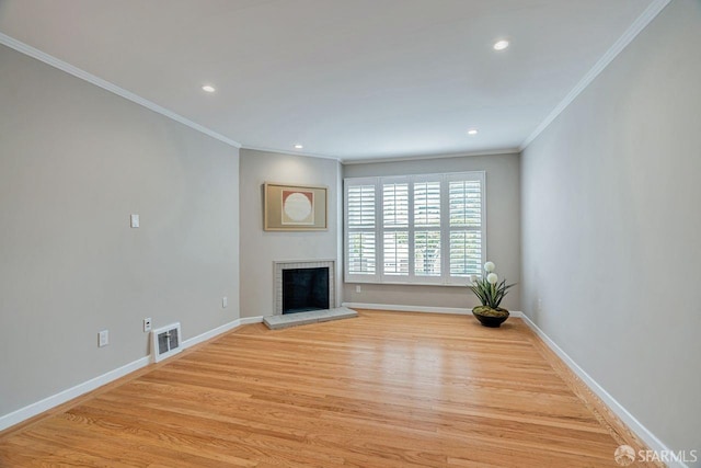 unfurnished living room with visible vents, baseboards, light wood-style flooring, a fireplace, and recessed lighting