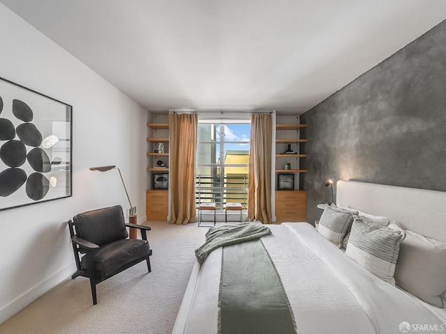 bedroom featuring carpet floors and baseboards