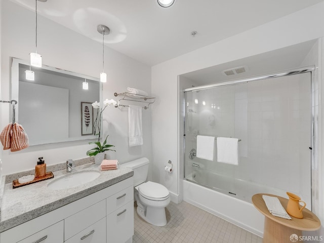 bathroom with visible vents, toilet, tile patterned floors, combined bath / shower with glass door, and vanity