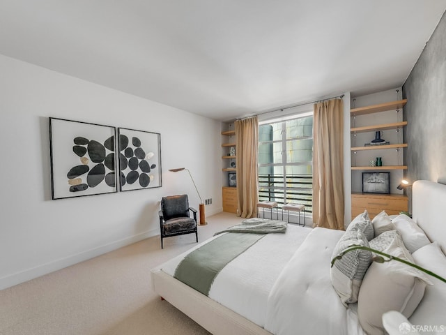 bedroom featuring carpet and baseboards