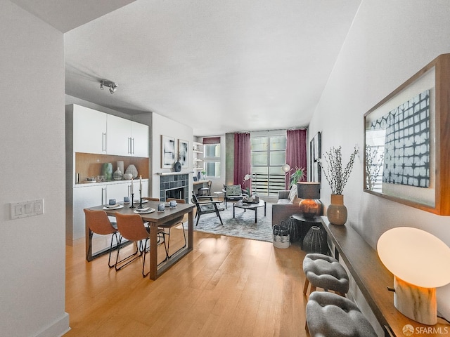 living area featuring a tiled fireplace and light wood finished floors