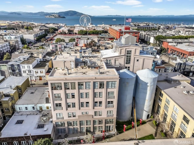 birds eye view of property with a water and mountain view and a city view