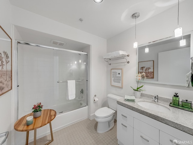 bathroom featuring toilet, shower / bath combination with glass door, vanity, visible vents, and tile patterned floors