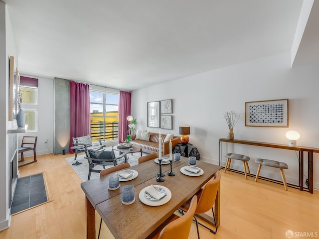 dining room with baseboards and light wood-style floors