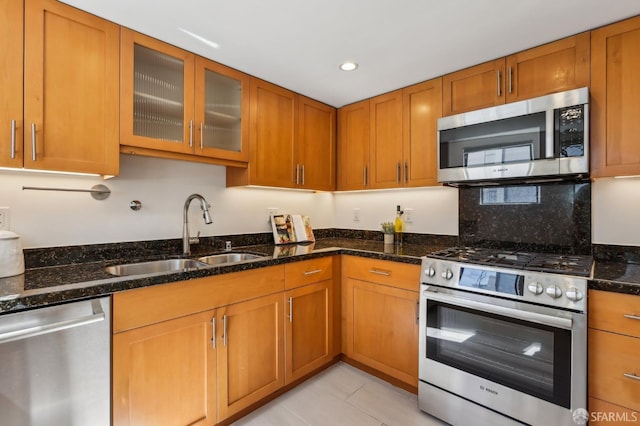 239 8th St Unit 14, San Francisco, CA 94103 - kitchen featuring appliances with stainless steel finishes, a sink, brown cabinets, and recessed lighting