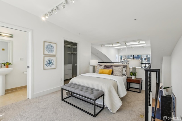239 8th St Unit 14, San Francisco, CA 94103 - bedroom with track lighting, carpet flooring, ensuite bath, and a closet