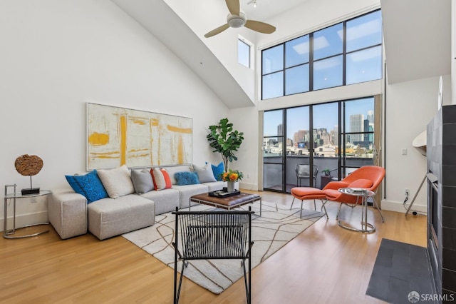 239 8th St Unit 14, San Francisco, CA 94103 - living area featuring a high ceiling, wood finished floors, ceiling fan, a view of city, and baseboards