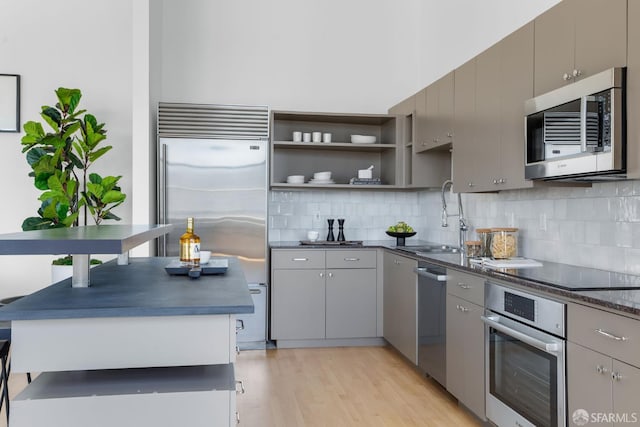 151 Alice B Toklas Pl Unit 610, San Francisco, CA 94109 - kitchen with stainless steel appliances, gray cabinets, dark countertops, a sink, and decorative backsplash