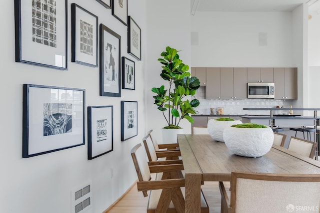151 Alice B Toklas Pl Unit 610, San Francisco, CA 94109 - dining room featuring a towering ceiling and light wood finished floors