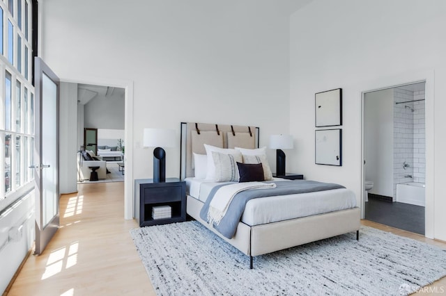 151 Alice B Toklas Pl Unit 610, San Francisco, CA 94109 - bedroom with light wood-style floors, connected bathroom, and a high ceiling