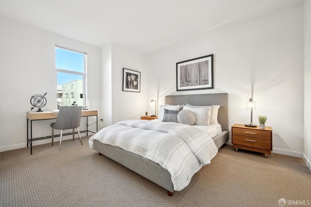 carpeted bedroom featuring baseboard heating