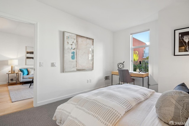 bedroom with wood-type flooring