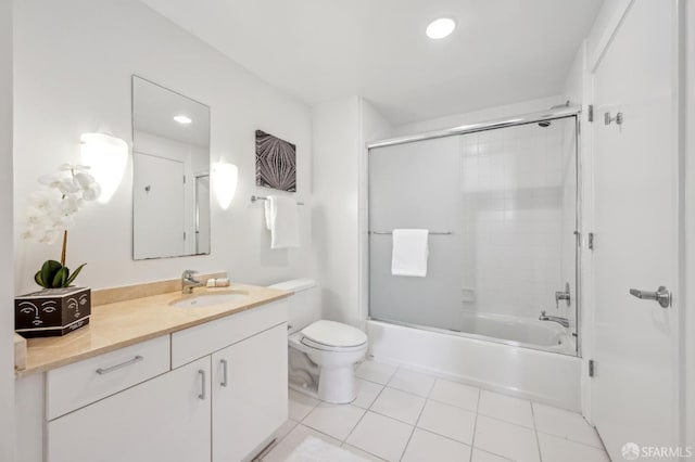 full bathroom with tile patterned flooring, vanity, toilet, and enclosed tub / shower combo