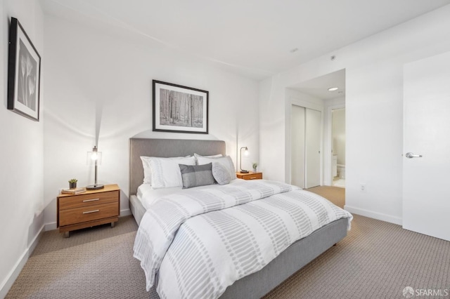 carpeted bedroom featuring ensuite bathroom