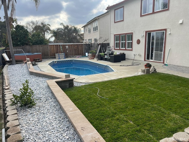 view of pool featuring an outdoor living space, a hot tub, a yard, and a patio area