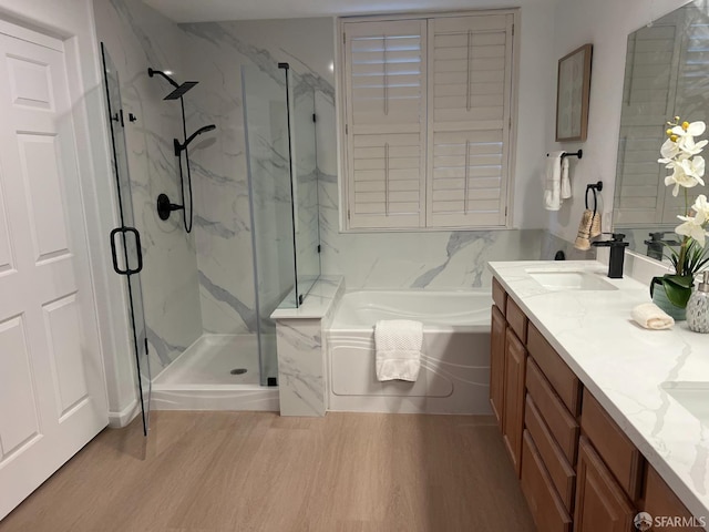 bathroom with vanity, hardwood / wood-style floors, and shower with separate bathtub