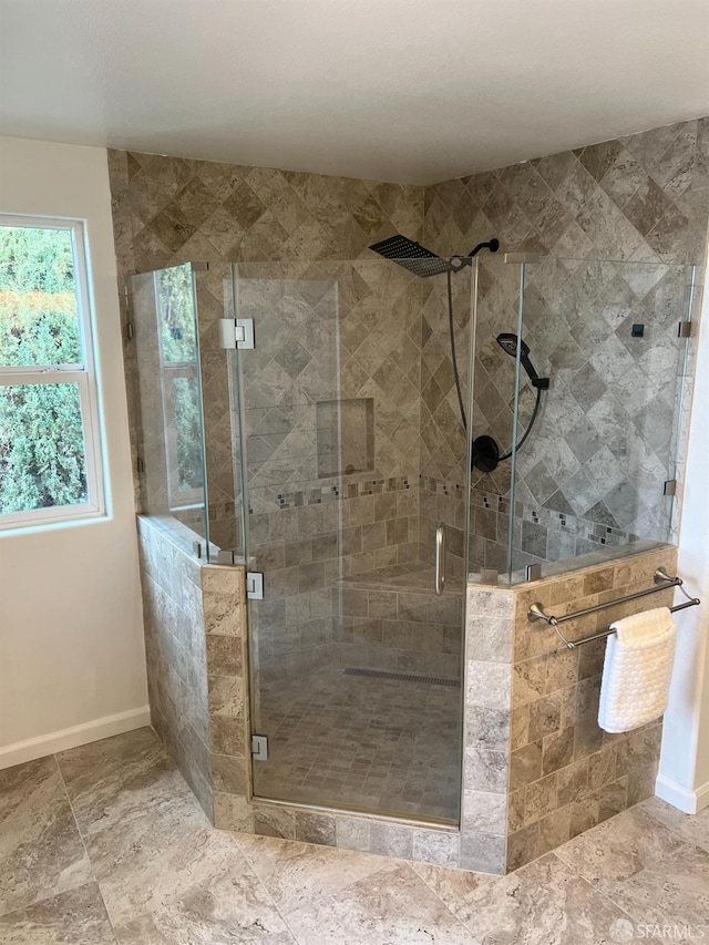 bathroom featuring a shower with door