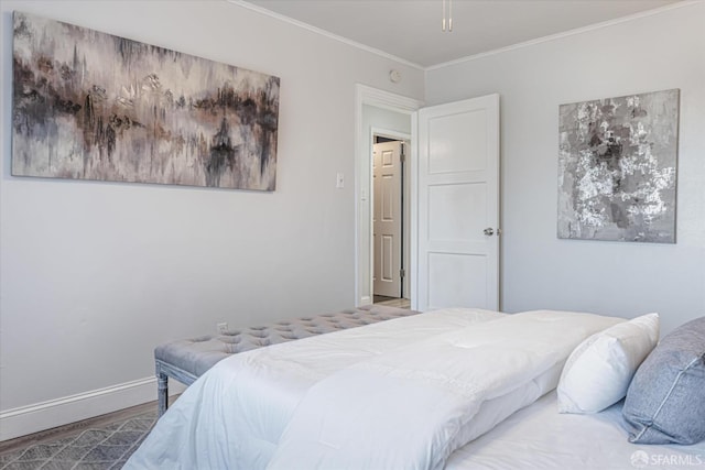 bedroom with baseboards, ornamental molding, and wood finished floors