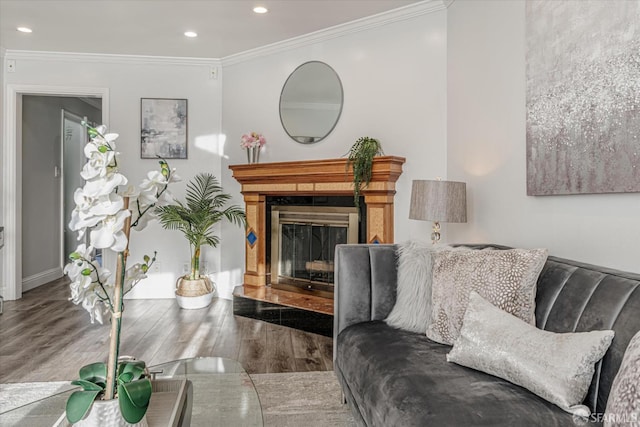 living room with ornamental molding, a high end fireplace, recessed lighting, and wood finished floors