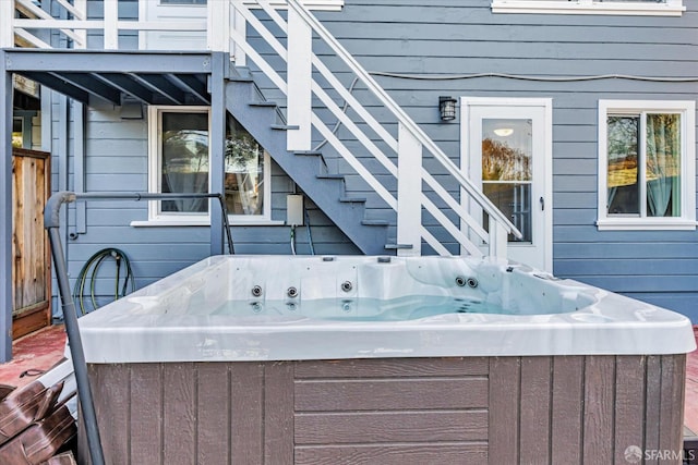 exterior space featuring stairs and a hot tub