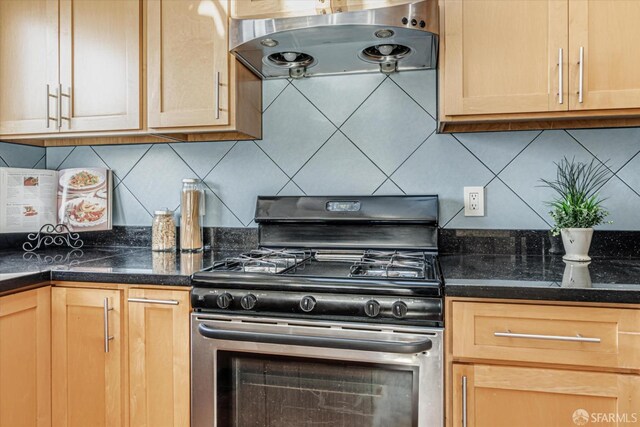kitchen featuring extractor fan, light brown cabinetry, decorative backsplash, and gas stove