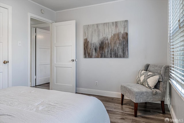 bedroom with dark wood-style floors, ornamental molding, and baseboards