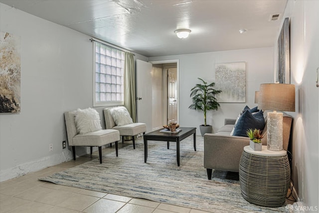 living area with light tile patterned floors and visible vents