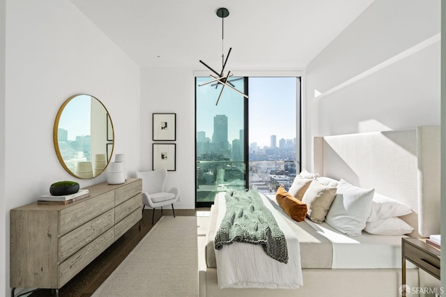 bedroom with expansive windows, dark wood-type flooring, and a chandelier