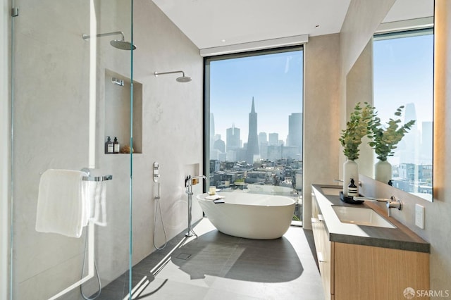 bathroom with plenty of natural light, a wall of windows, separate shower and tub, and vanity