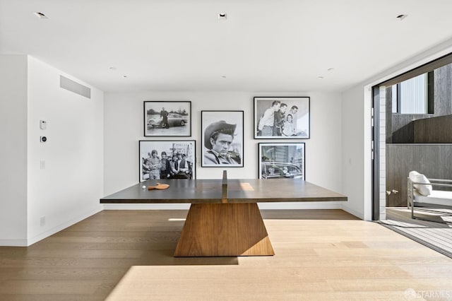 unfurnished dining area with wood-type flooring