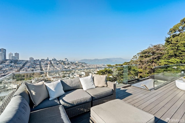 wooden deck featuring a mountain view and an outdoor living space