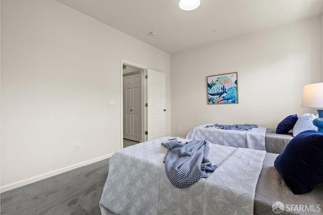 bedroom with baseboards and carpet