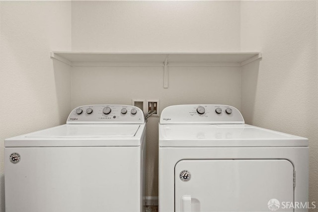 washroom featuring washing machine and clothes dryer and laundry area