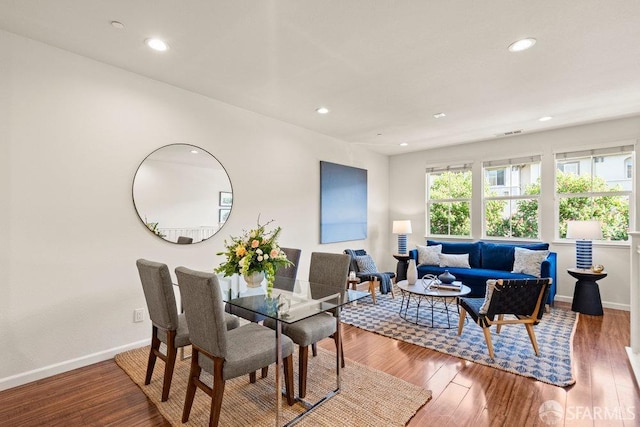 dining space featuring recessed lighting, baseboards, and wood finished floors