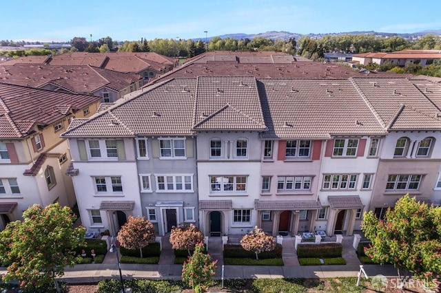drone / aerial view featuring a residential view and a mountain view