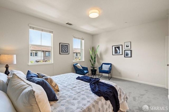 bedroom featuring visible vents, carpet flooring, and baseboards