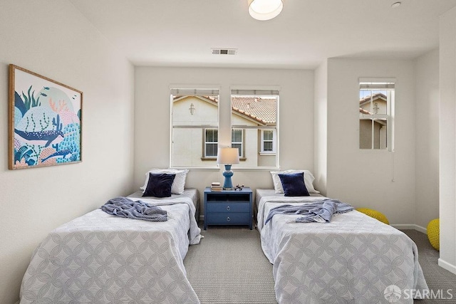 bedroom featuring baseboards, visible vents, and carpet