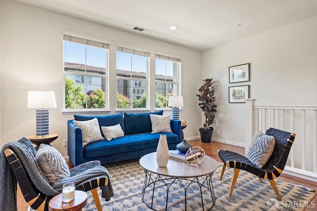 living area with visible vents, recessed lighting, baseboards, and wood finished floors