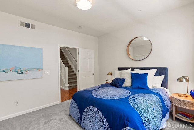 bedroom featuring carpet flooring, baseboards, and visible vents